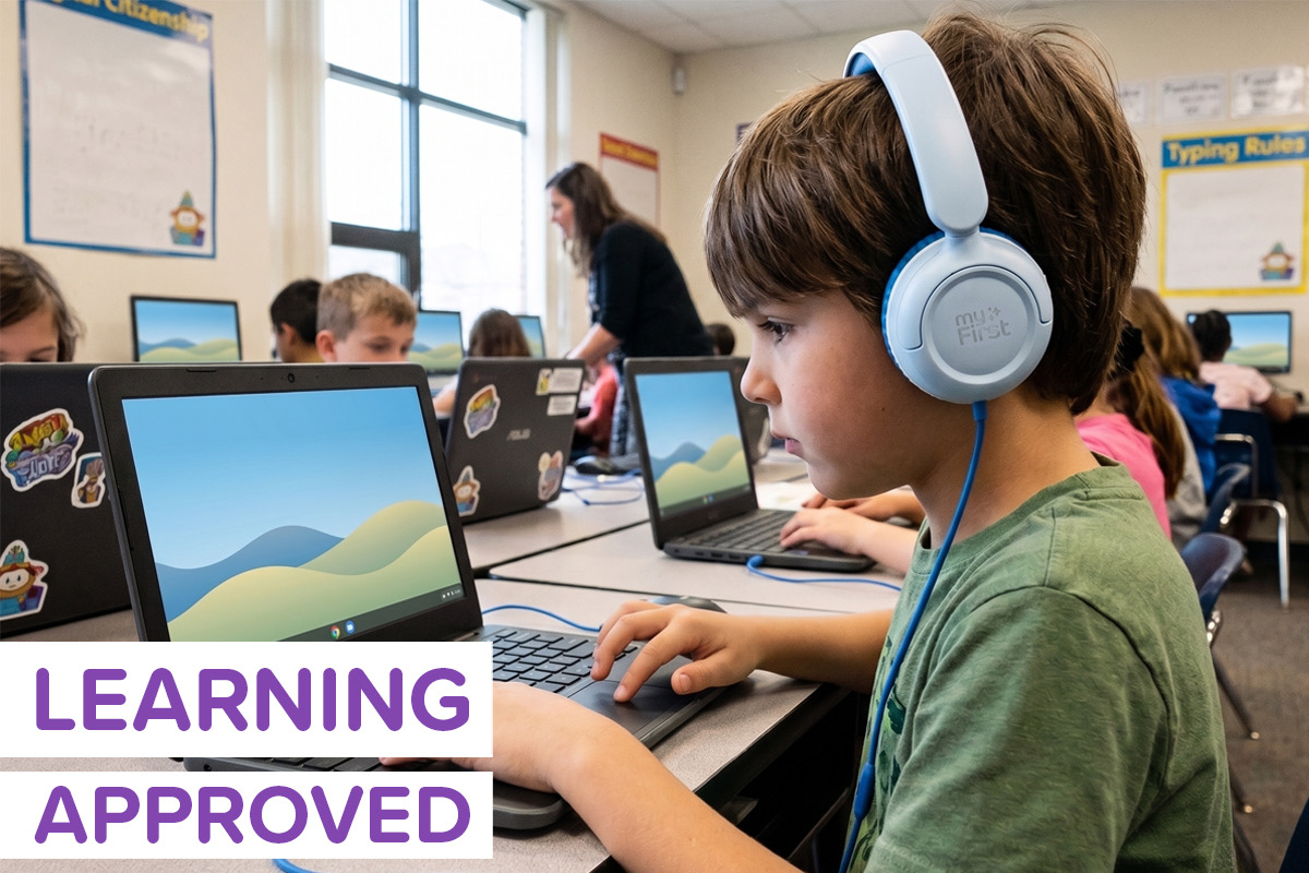 A boy sitting in a computer lab wearing myFirst Link W1 headphones